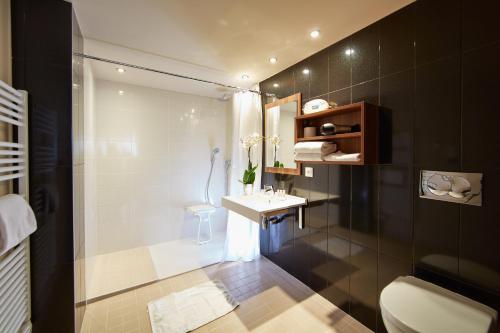 a bathroom with a shower and a sink and a toilet at Best Western Hotel Atrium Valence in Valence