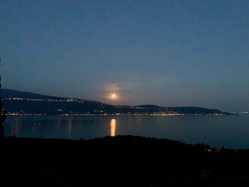 a view of a large body of water at night at Agriturismo Cervano in Toscolano Maderno