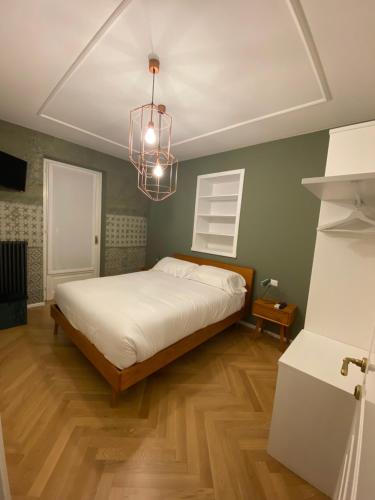 a bedroom with a bed and a chandelier at Camere La Meridiana in Domodossola