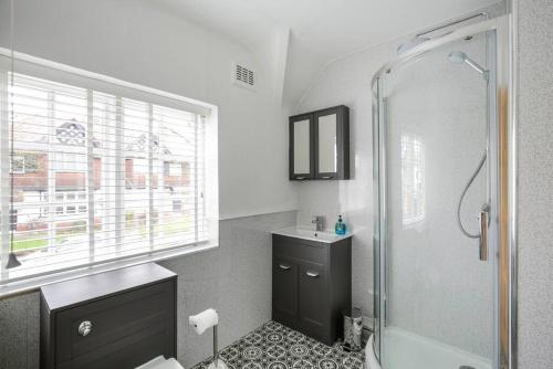 a bathroom with a shower and a sink at Duke of York Cottage, Port Sunlight in Wirral