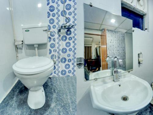 a bathroom with a white toilet and a sink at Itsy Hotels Buddha Inn in Patna