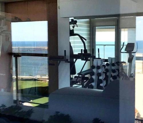 a room with a gym with a view of the ocean at deptomardel_playa in Mar del Plata