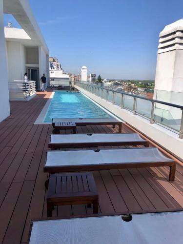 a swimming pool on the roof of a building at deptomardel_playa in Mar del Plata