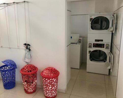 a kitchen with two trash cans and a microwave at deptomardel_playa in Mar del Plata