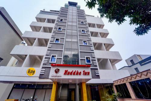 a tall building with a red sign on it at Itsy Hotels Buddha Inn in Patna