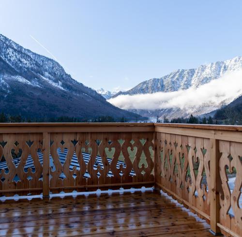 a wooden balcony with a view of mountains at Haus Stangl in Bad Aussee
