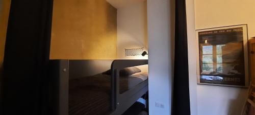 a bedroom with a bunk bed and a mirror at Transhumance & cie, Auberge, Appartements & SPA in Bedous