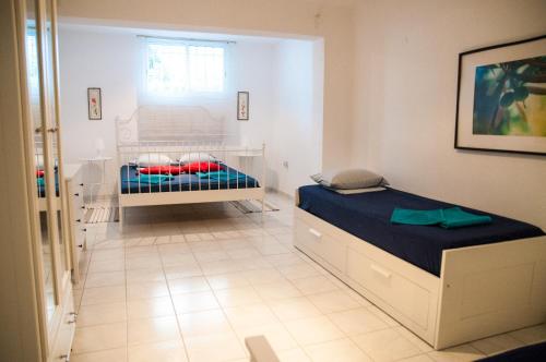 a bedroom with a bed in a room at Alexger Gerakini Beach house view in Gerakini
