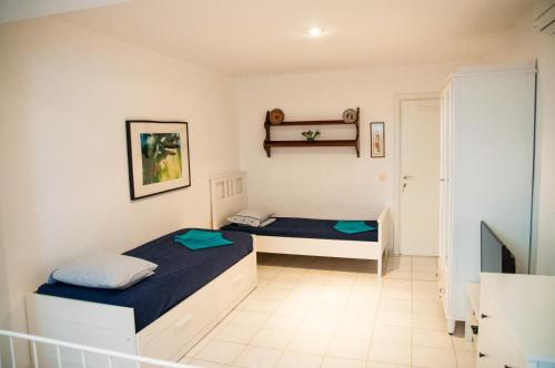 a bedroom with two beds in a room at Alexger Gerakini Beach house view in Gerakini