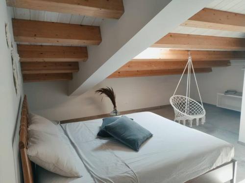 a bedroom with a bed and a swing in a attic at Villa Cirasa in Aragona