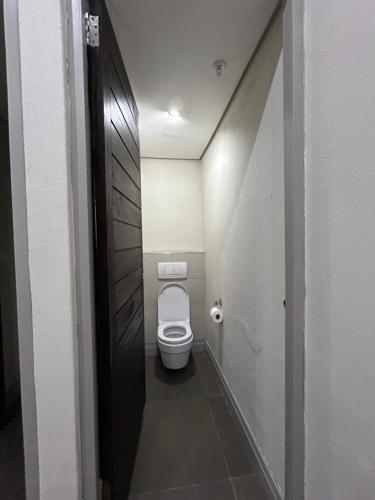 a small bathroom with a toilet in a stall at Meridian Suite Apartments in Umhlanga Ridge in Durban