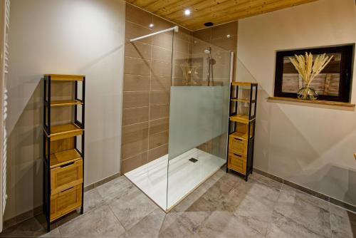 a shower room with a glass shower stall at Les balcons de Cuttura 2 chez Ô JurassiK in Cuttura