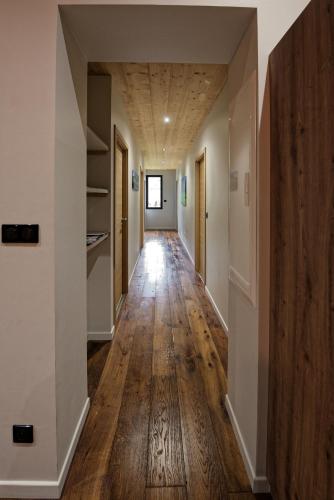 an empty hallway in a house with wood floors and ceilings at Les balcons de Cuttura 2 & SPA chez Ô JurassiK in Cuttura