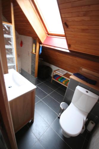 une salle de bain avec des toilettes blanches et un lavabo dans l'établissement La Maison Imparfaite, à Fourbanne