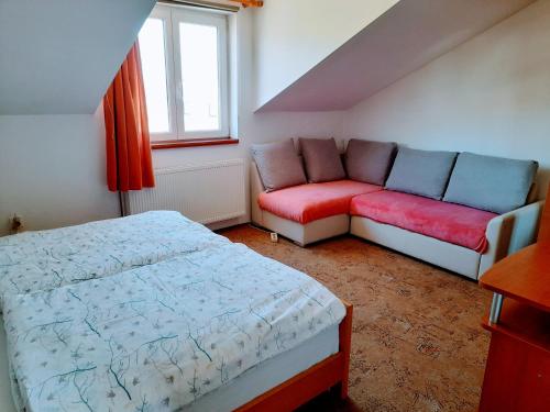 - une petite chambre avec un lit et un canapé dans l'établissement Apartments Tiho&Marija, à Tribunj