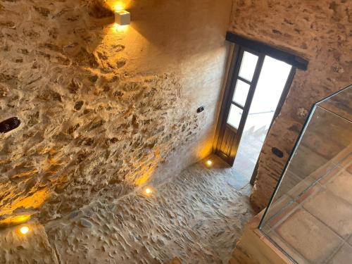 an overhead view of a stone wall with a window at Balcón de la Moreria con alberca in Constantina