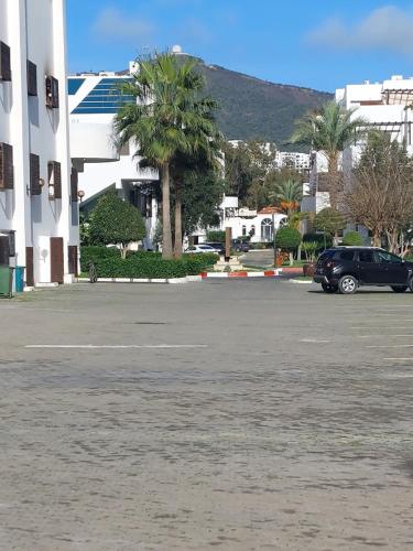 a parking lot with a car parked in front of a building at la Cassia Cabo Appartement in Cabo Negro