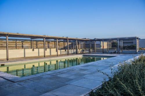 a pool of water in front of a building at Benguela Cove - Oceans Away in Hermanus