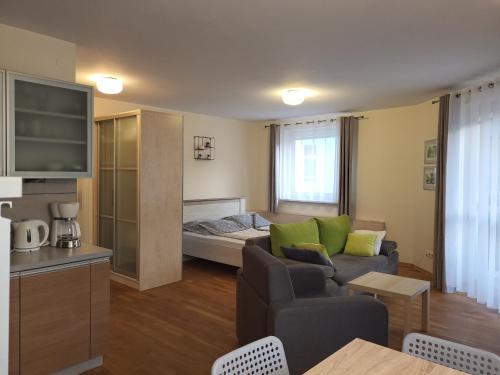 a living room with a couch and a bed at Apartamenty Bystrzycka - Bliżej Zdroju in Polanica-Zdrój
