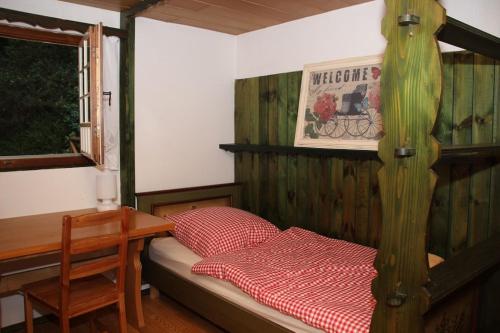 a bedroom with a bed and a desk and a bed and a table at Black Forest House in Wolfach