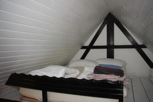 a small room with a bed in a attic at Black Forest House in Wolfach