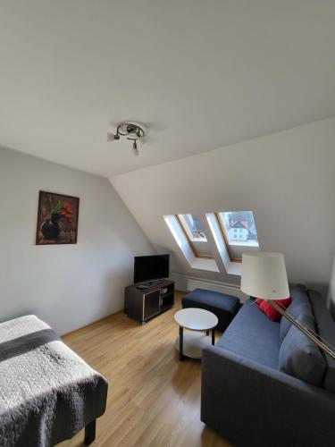 a living room with a couch and a table at Apartament 3 - Bliżej Zdroju in Polanica-Zdrój
