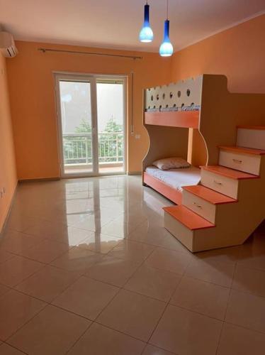 a bedroom with a bunk bed and a large window at Lovely 2 bedroom unit with beach view in Golem