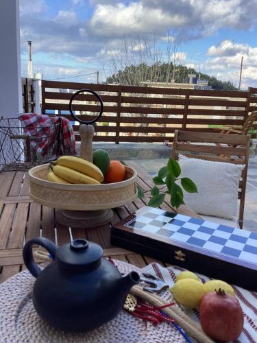 a table with a bowl of fruit on a deck at Casa Charma in Émbonas