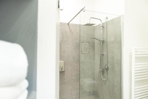 a bathroom with a shower with a glass door at Suite Apartments - Corso51 in Rimini
