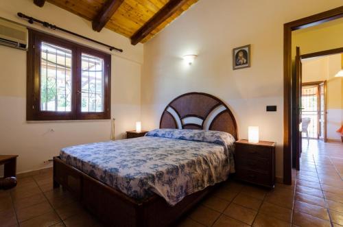 a bedroom with a large bed and two night stands at Villa Nina in Arenella