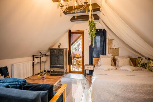 a bedroom with a bed and a couch and a fireplace at Hanul Anei Studios and Apartments Brasov Transylvania in Braşov