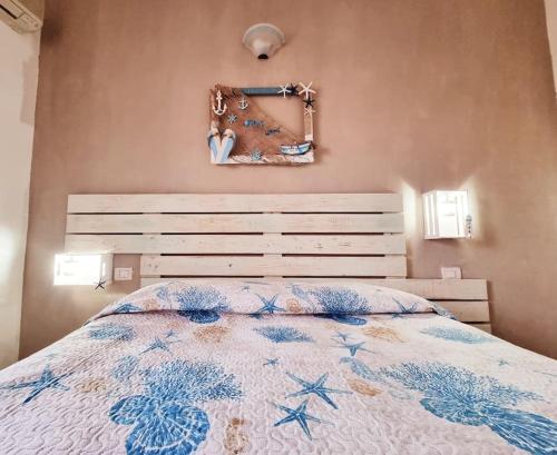 a bedroom with a bed with a blue and white comforter at Mojito's house in Rio Marina