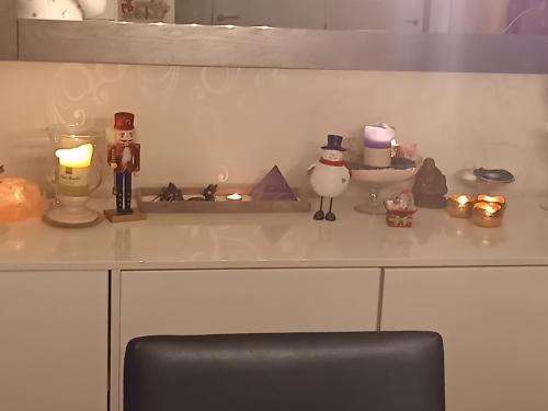 a counter top with figurines and candles on it at CASA Victoria in Kuringen