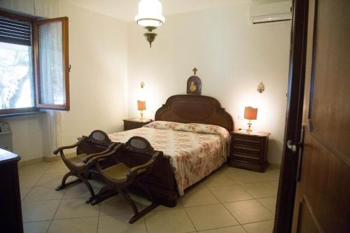 a bedroom with a bed and a chair in it at APPARTAMENTI PANORAMICI VISTA MARE in Castiglione della Pescaia