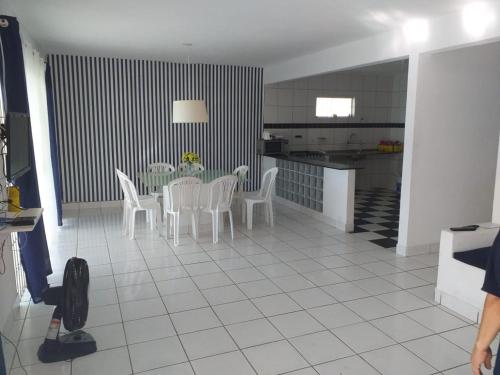 a kitchen and dining room with a table and chairs at Casa Beira Mar Serrambi in Porto De Galinhas