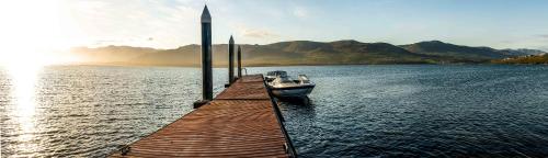 a boat is docked at a dock in the water at Benguela Cove - Oceans Away in Hermanus