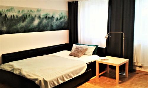 a small bedroom with a bed and a table at Meisterhaus Alpirsbach Wohnung OG in Alpirsbach