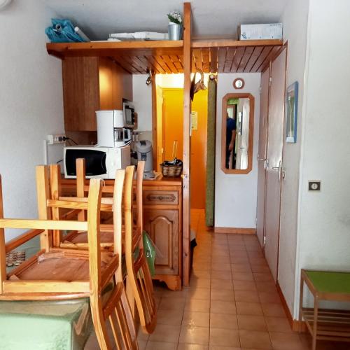 a kitchen with a table and chairs in a room at Le stella Ancelle in Ancelle