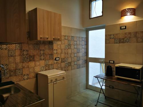 a small kitchen with a sink and a window at LA VECCHIA TORRE 1920 in Grottaglie