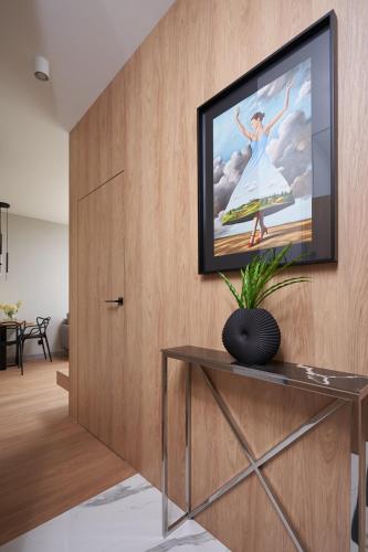 a living room with a television on a wall at Apartamenty Olimpijska by RENT4YOU in Olsztyn