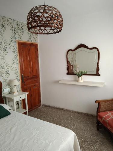 a bedroom with a bed and a mirror on the wall at La Casica in Chulilla