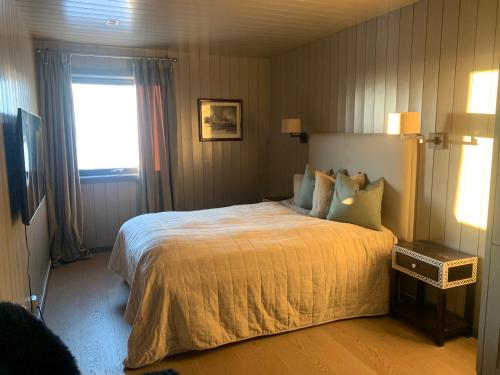 ein Schlafzimmer mit einem großen Bett und einem Fenster in der Unterkunft Appartment Norefjell ski in/ski out in Noresund