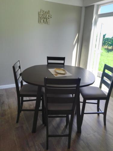 a dining room table with four chairs and a table and a table and chairsktop at 2 Bedroom Residential Rental Unit in Paix Bouche