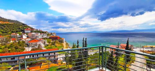 a view from a balcony of a city and the water at Mitho Hotel Spa in Loutra Edipsou