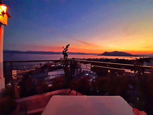 a statue on top of a building at sunset at Mitho Hotel Spa in Loutra Edipsou