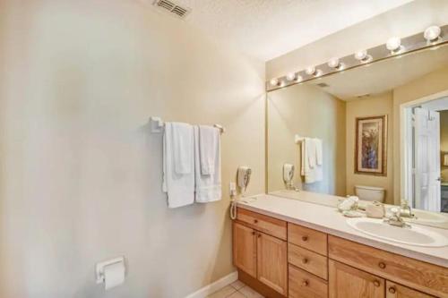 a bathroom with a sink and a mirror at Veteran Owned 3bdr/3 bath Townhouse w/WiFi 3mi to Disney - Winter/Spring Specials in Kissimmee