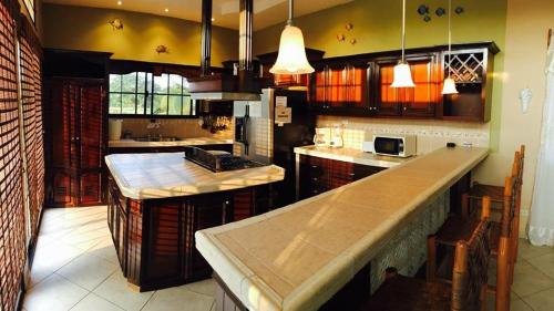 a large kitchen with a large island in the middle at Casa Lila in Tela