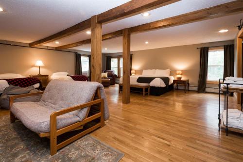 uma sala de estar com uma cama e um quarto em The Lodge at Pleasant Point em Lovell
