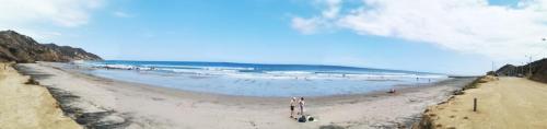 a group of people standing on a beach at Acogedora suite en Liguiqui - Manta in Aromo