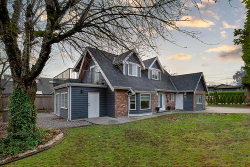 a house with a gambrel roof at Spacious & Modern by the Beach in White Rock